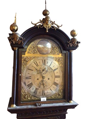 Lot 1089 - 18th century 8 day longcase clock, the arched brass dial with silvered chapter ring and subsidiary date and second dials, in an oak case with later carved decoration, 228cm.