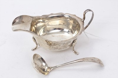 Lot 413 - 1930s silver sauce boat of conventional form with loop handle on four pad feet (Sheffield 1937) E.Viner together with a matching ladle (same date and maker) All at approximately 4ozs. Sauceboat 1...