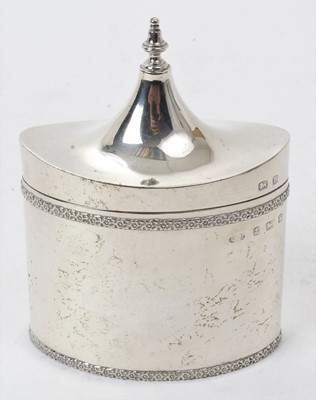 Lot 417 - George V silver Arts and Crafts tea caddy of tall oval form with decorative floral borders