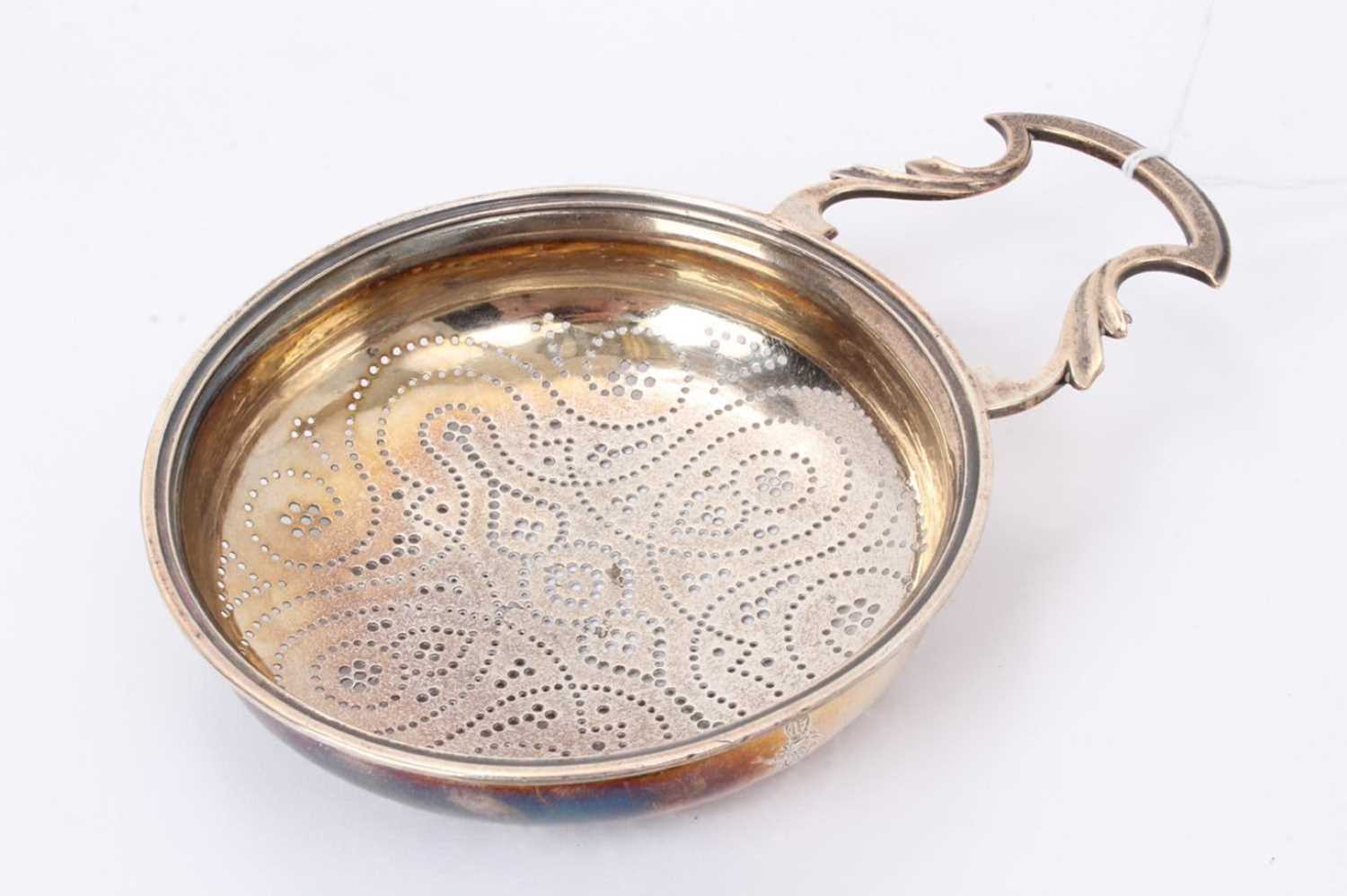 Lot 583 - Georgian silver lemon squeezer of circular form, with pierced bowl, engraved armori