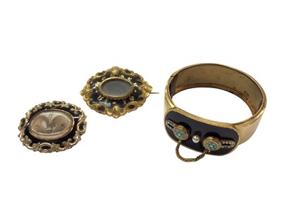 Lot 1082 - Victorian gilt metal and black enamel bangle set with seed pearls and turquoise cabochons, together with two Victorian mourning brooches