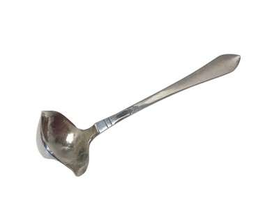 Lot 14 - A Georg Jensen Danish silver double-lipped cream ladle with hammered bowl, Copenhagen mark for 1924, London import marks, 12.5cm long