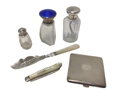 Lot 24 - Group of silver, including a compact, a mother-of-pearl handled knife and penknife, a guilloche enamel topped glass bottle and two other silver topped bottles (6)