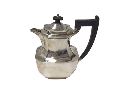 Lot 33 - A silver hot water jug, of octagonal form with ebonised handle and knop, Sheffield 1955, 19cm high, 21.4oz