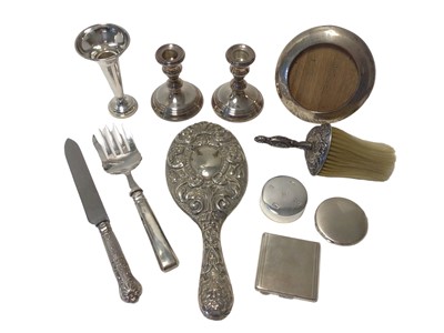 Lot 35 - Group of silver, mostly dressing table items, including a pair of weighted candlesticks, a weighted spill vase, a frame, a paperweight, silver-handled serving knife and fork, mirror and brush with...