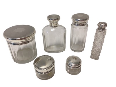 Lot 39 - Group of six silver-topped glass bottles and jars, including a set of three with engine-turned decoration