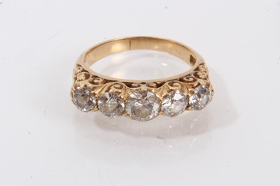 Lot 599 - Late Victorian 18ct gold diamond five stone ring with five graduating old European cut diamonds, estimated to weigh approximately 1.15cts in total, in carved scroll setting, size L