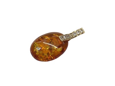 Lot 1052 - 14ct gold mounted amber drop pendant set with synthetic white stones, 5cm long