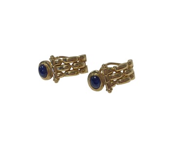 Lot 140 - Pair of 18ct gold earrings with a chain-like design, each set with a blue cabochon, 22mm long, 5.7g