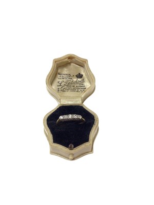 Lot 143 - Early 20th century diamond five stone ring with five graduated old cut diamonds in platinum claw setting on 18ct gold shank. Estimated total diamond weight approximately 0.20cts. Ring size M.