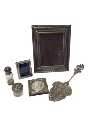 Lot 71 - Silver photograph frame, two smaller silver frames, white metal mounted glass scent bottle with vinaigrette to base, silver mounted glass jar and a Continental white metal spoon
