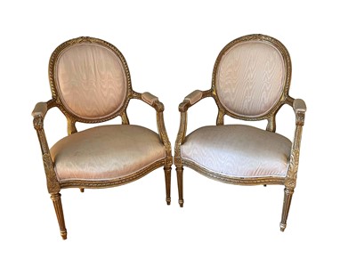 Lot 1139 - Pair of Louis XVI style giltwood fauteuils, each with carved gilt showwood frame and shot silk on fluted tapered legs