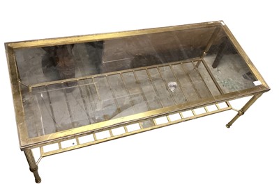 Lot 1256 - Gilded metal and glazed coffee table, on fluted supports with magazine rack below, 105cm wide x 48cm deep x 40cm high