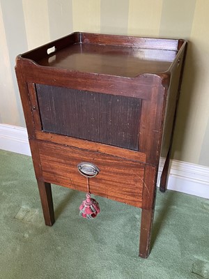 Lot 1073 - George III mahogany beside cupboard, with pierced gallery and enclosed by tambour slide with pot drawer below, on square legs, 48cm wide 44cm deep x 78cm high