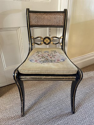 Lot 1259 - Regency caned black painted side chair on sabre legs