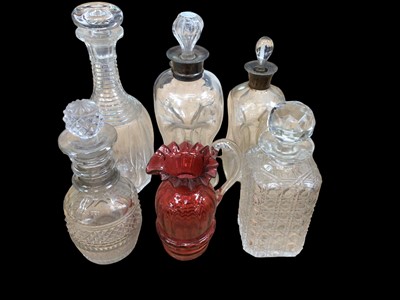 Lot 20 - Two waisted glass decanters with silver collars, three other antique decanters and a cranberry glass jug (6)