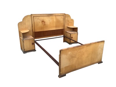 Lot 1261 - Art Deco walnut veneered bedroom suite; comprising a headboard with two fitted bedsides, wardrobe, chest of drawers, dressing table and matching footstool (5) (located bedroom I)