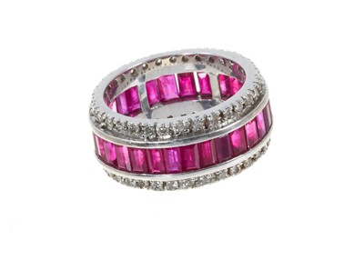 Lot 312 - Ruby and diamond eternity ring in 18ct white gold setting