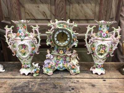 Lot 39 - Continental porcelain clock garniture, with figural and floral decoration, enamel dial, 35cm high