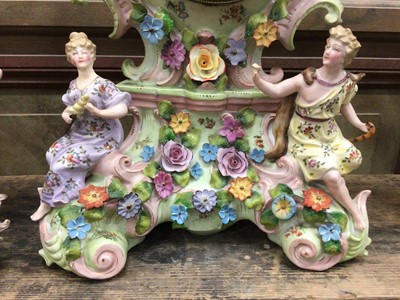 Lot 39 - Continental porcelain clock garniture, with figural and floral decoration, enamel dial, 35cm high