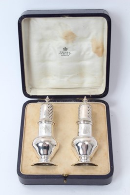 Lot 186 - Pair of Asprey silver pepperettes in fitted case