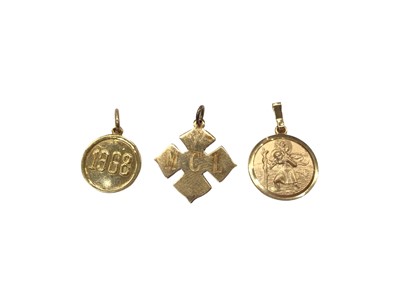 Lot 1025 - 9ct gold St. Christopher pendant, cross shaped pendant stamped 14K and a 1968 disc pendant stamped K18