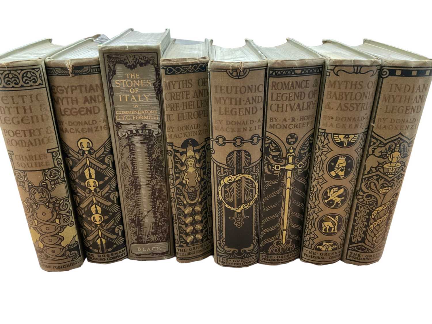 Lot 1704 - Set of seven Donald A Mackenzie books, with decorative cloth binding, one further decorative binding