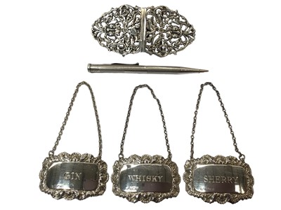 Lot 1071 - Three silver spirit labels, together with a silver nurses’ buckle and a silver propelling pencil