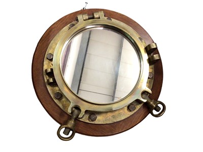 Lot 313 - Brass ship's port hole mirror on circular wooden wall mount