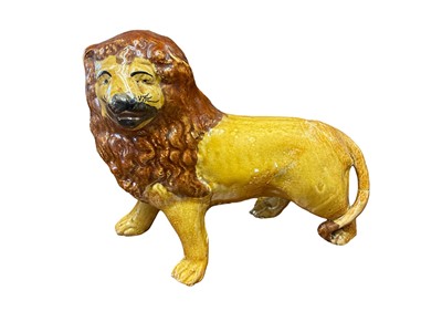 Lot 245 - 19th century Staffordshire pottery figure of a lion, 21cm long