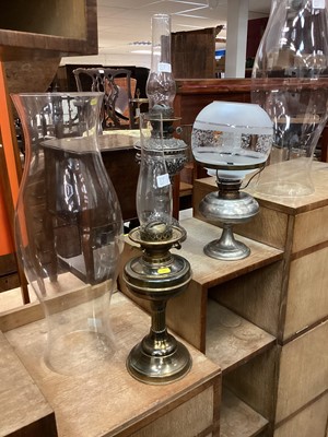 Lot 253 - Three replica oil lamps and a large pair of glass storm lantern glasses