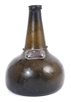 Lot 1264 - Early 18th century blown glass onion wine bottle, with silver wine label