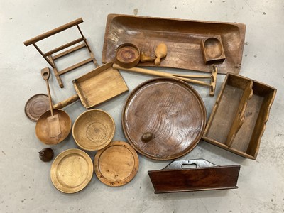 Lot 1356 - Group of treen including 19th century elm charger, 43cm diameter plater, dough trough etc