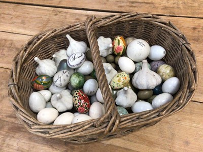 Lot 1380 - Collection of ceramic and other eggs and ceramic garlic bulbs housed in a basket