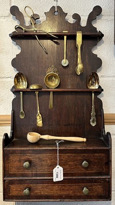 Lot 1398 - George III oak spoon rack, housing collection of brass spoons and other items