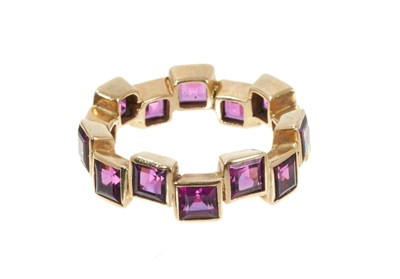 Lot 342 - Amethyst and gold eternity ring