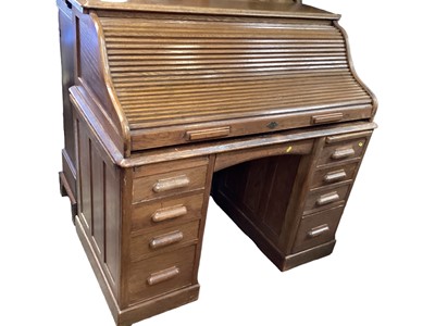 Lot 1244 - Early 20th century oak roll top desk with tambour shutter, fitted interior and nine drawers below, 122cm wide, 68cm deep, 117.5 cm wide