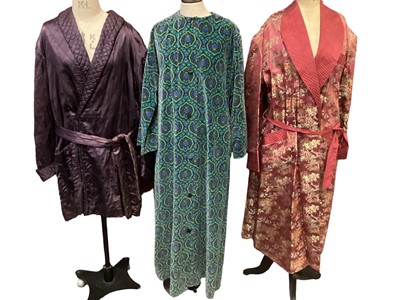 Lot 2064 - Floral printed velvet (FM label) button through housecoat / dress, Gentlemen's quilted maroon smoker's jacket by Meakers and a full length chinese dressing gown.