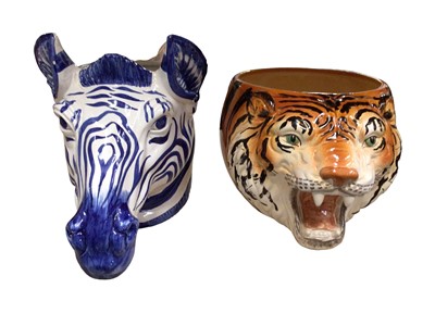 Lot 366 - Two painted pottery animal head jardinières in the form of a zebra and tiger