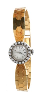 Lot 441 - 1950s ladies 18ct gold Omega wristwatch with diamond bezel