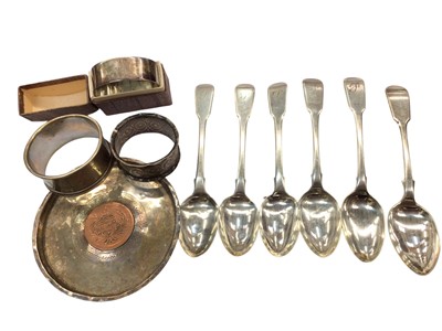 Lot 1053 - Five Georgian silver teaspoons, one plated spoon, three silver napkin rings and a white metal dish with coin mount