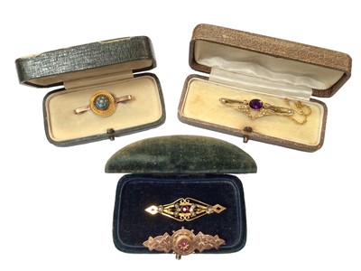 Lot 1057 - Four Late Victorian/ Edwardian 9ct gold gem set and seed pearl bar brooches, within three antique jewellery boxes