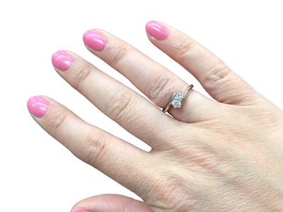 Lot 1095 - 18ct white gold diamond two stone cross over ring