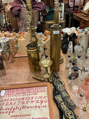 Lot 502 - Group of brassware to include a pair of lamps, horse brasses, trench art shell case jug and other pieces.