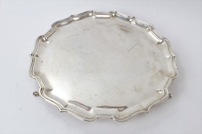 Lot 150 - 1930s silver salver of hexagonal form with piecrust border, on three hoof feet (Sheffield 1939)