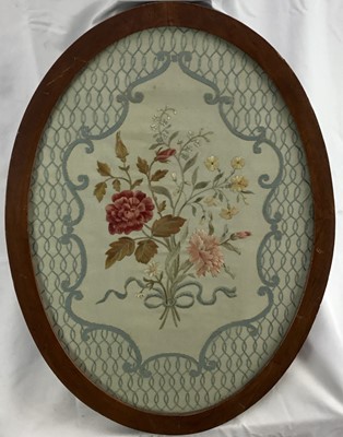 Lot 177 - Victorian silkwork oval embroidered panel, a bunch of flowers in a posy with ribbon all within a rococo and lattice border. In its original mahogany oval and glazed frame. 60.5x45cm