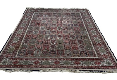 Lot 1336 - Large Kerman rug decorated with nunerous medallions on red, blue, green and cream ground, 330cm x 220cm