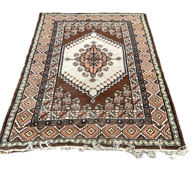 Lot 1338 - Eastern rug with central medallion on cream, brown and orange ground, 250cm x 164cm