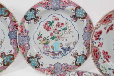 Lot 3 - Six Chinese famille rose export plates, Yongzheng and Qianlong, including two pairs decorated with flowers, and another pair with birds, fruit and flowers in vases, 23cm diameter