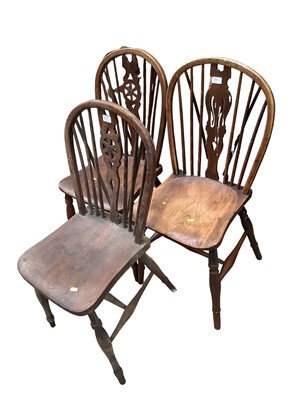 Lot 1370 - Six wheel back chairs comprising two carvers and four standards together with a similar chair (7)